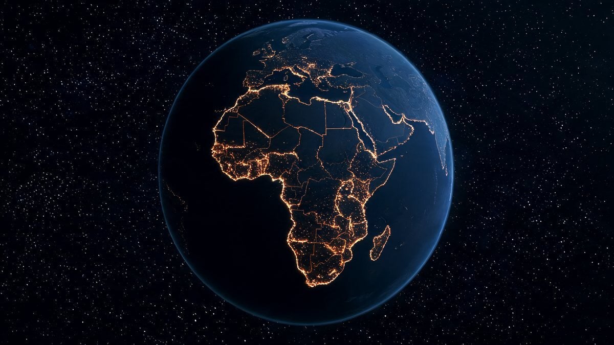 Earth at night centered on Africa with glowing orange city lights